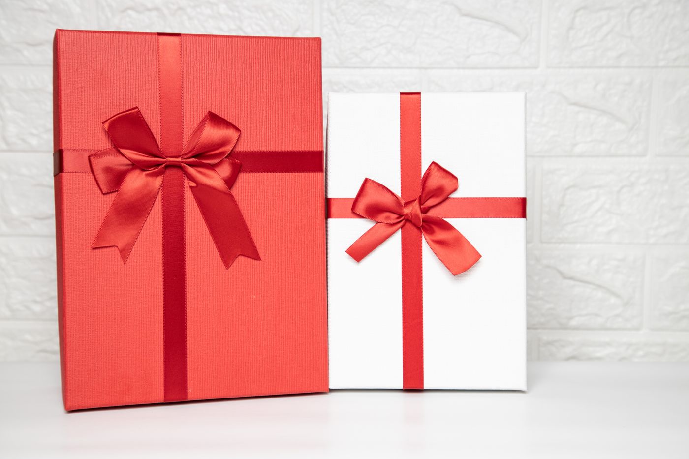keychain gift for teacher — Two beautifully wrapped gift boxes in red and white with satin ribbons on a white background