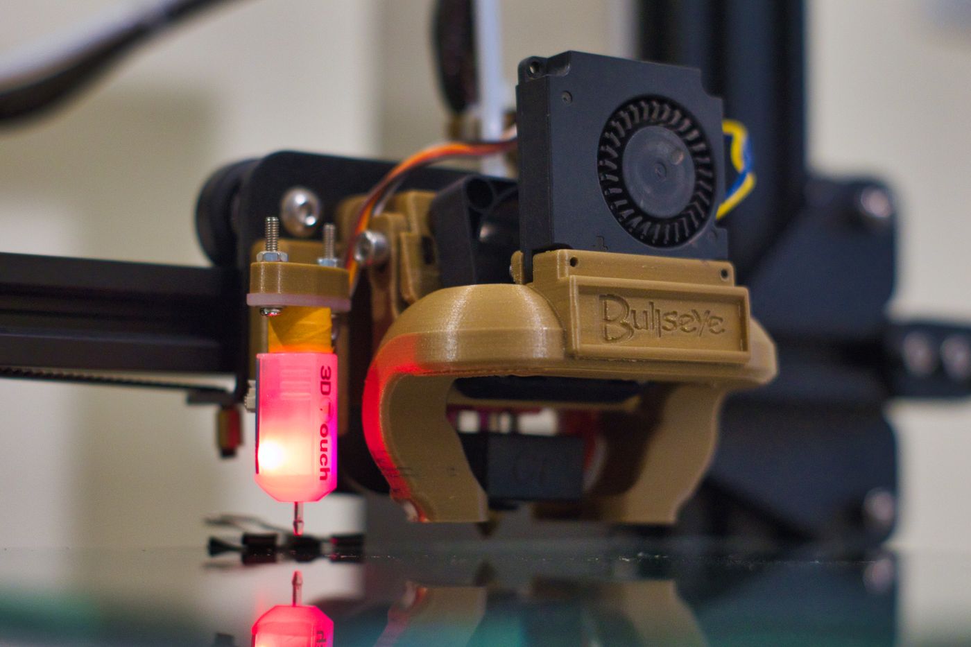 3d printing layer height — Detailed shot of a 3D printer nozzle operating in a workshop setting