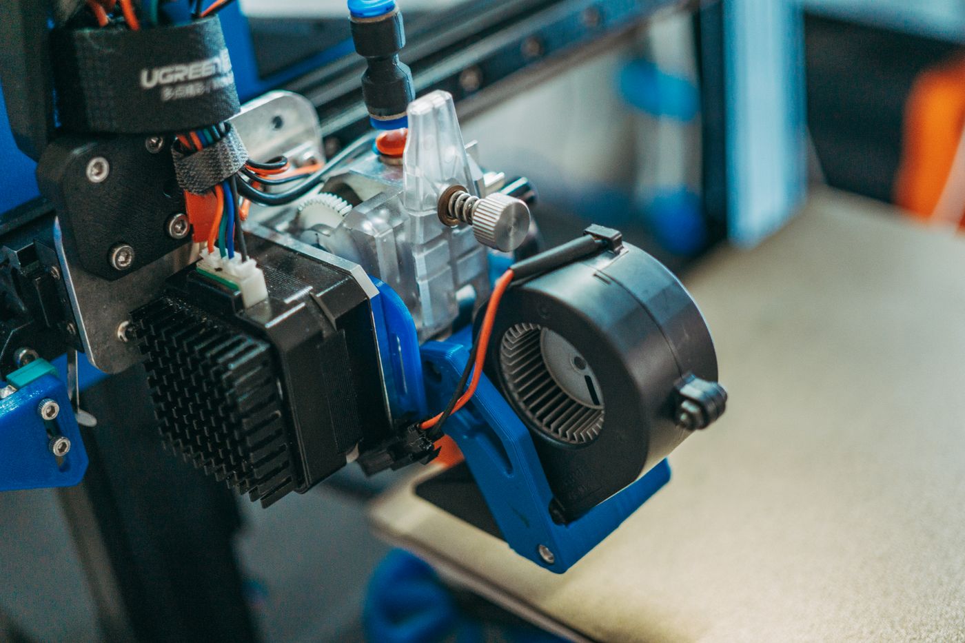 3d printing layer height — Detailed view of 3D printer parts showing wires and equipment in a workshop setting