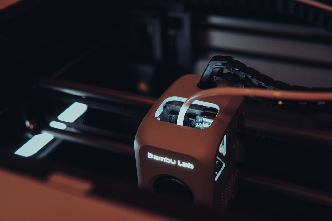 3d printer filament storage — Detailed view of a 3D printer mechanism in a dark setting, highlighting technology