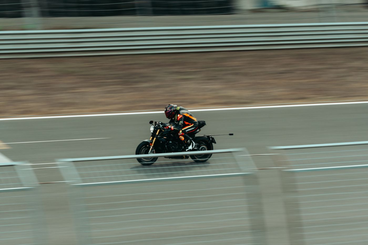3d printed accessories for bike — Blurred image of a motorcyclist racing at high speed on an outdoor track