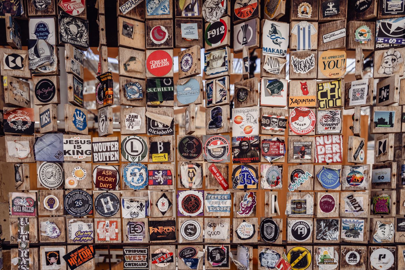 cartoon stickers for car — A vibrant assortment of stickers displayed on wooden panels in Valletta, Malta