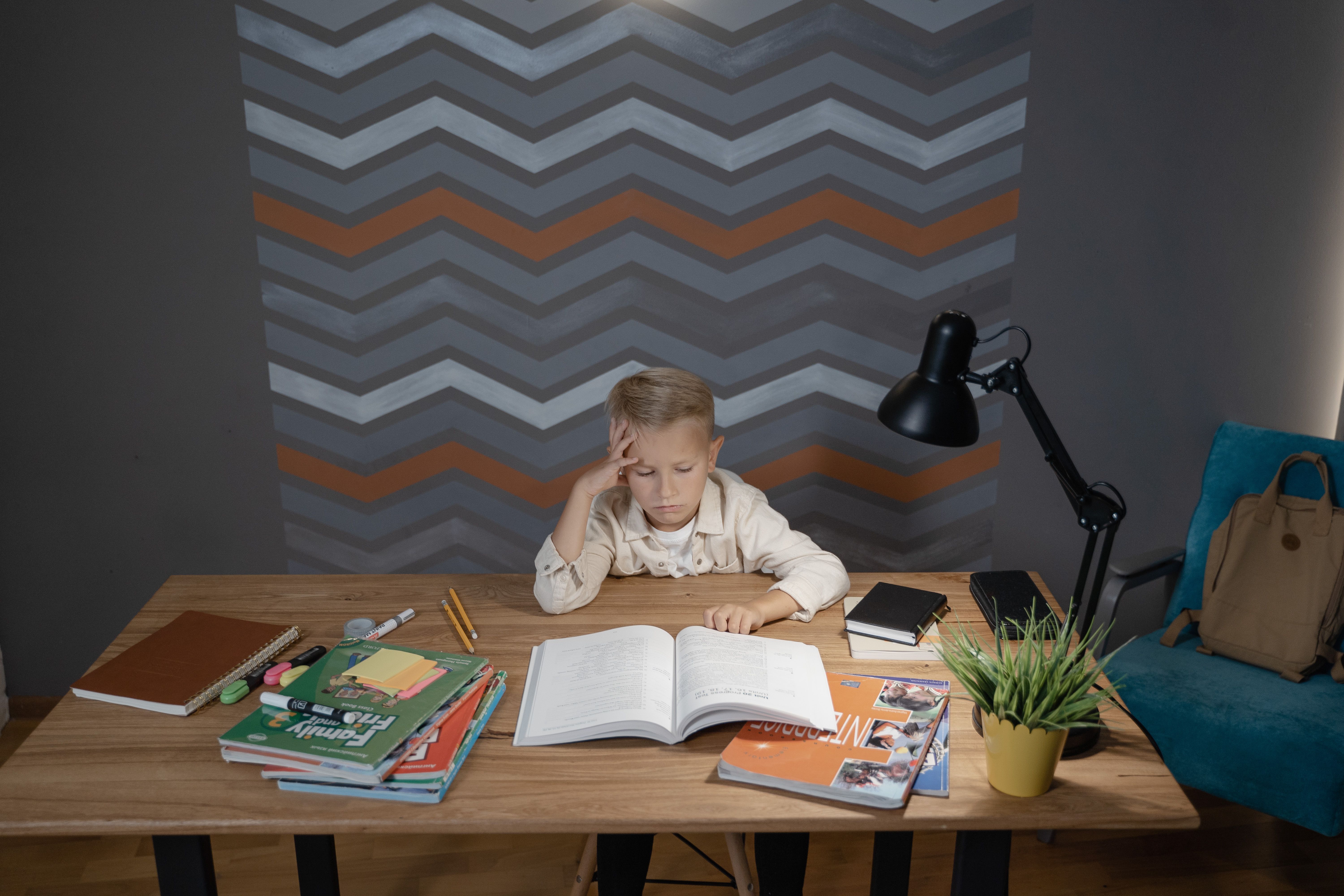 Cartoon stickers for study table — a schoolboy at a study desk surrounded by school supplies