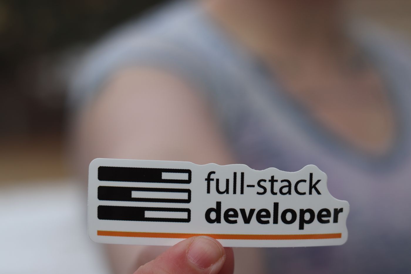 custom shape kiss cut stickers — A hand holding a sticker labeled 'full-stack developer', symbolizing technology and programming skills