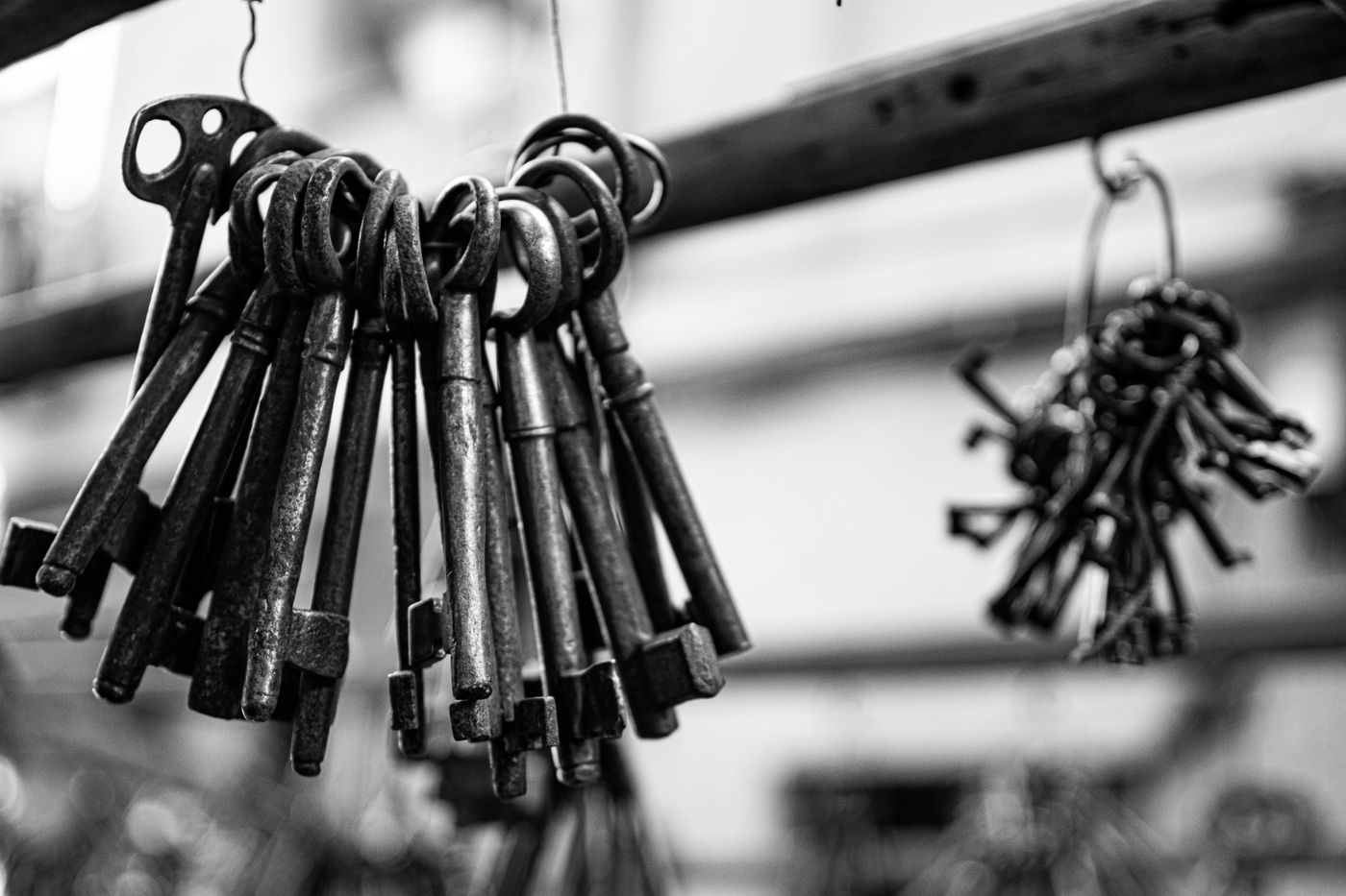 name keychain for water bottle — Close-up of vintage iron keys hanging, captured in black and white
