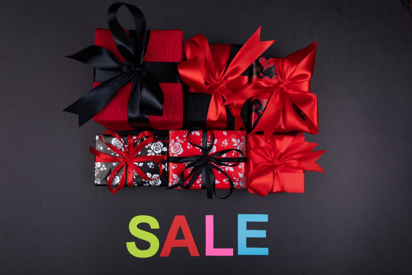 cartoon stickers for wall — Colorful gift boxes with bows arranged over a SALE sign, perfect for holiday promotions