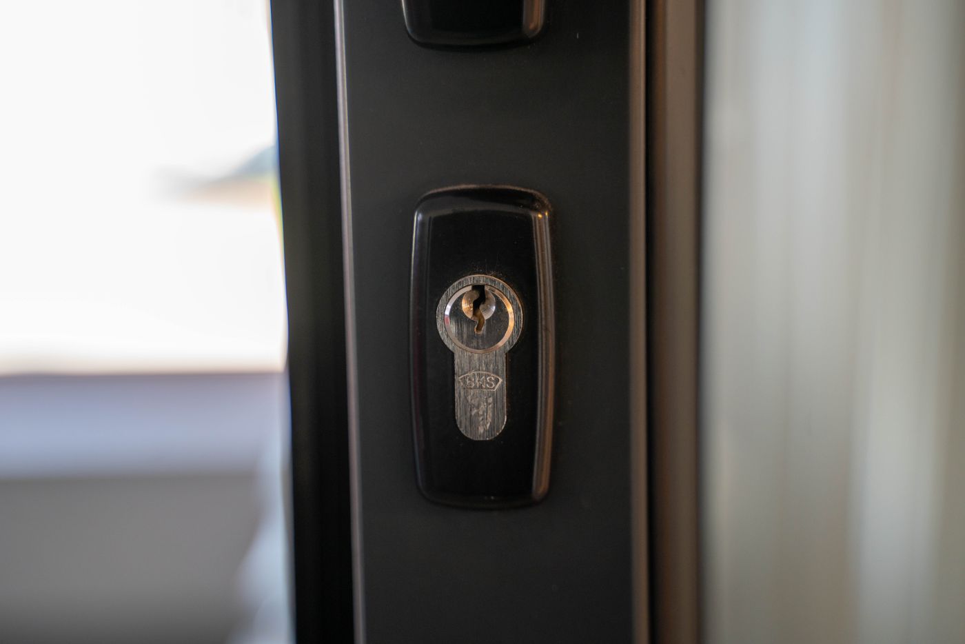 personalised keychain for house — Detailed view of a steel keyhole on a door ensuring security and privacy