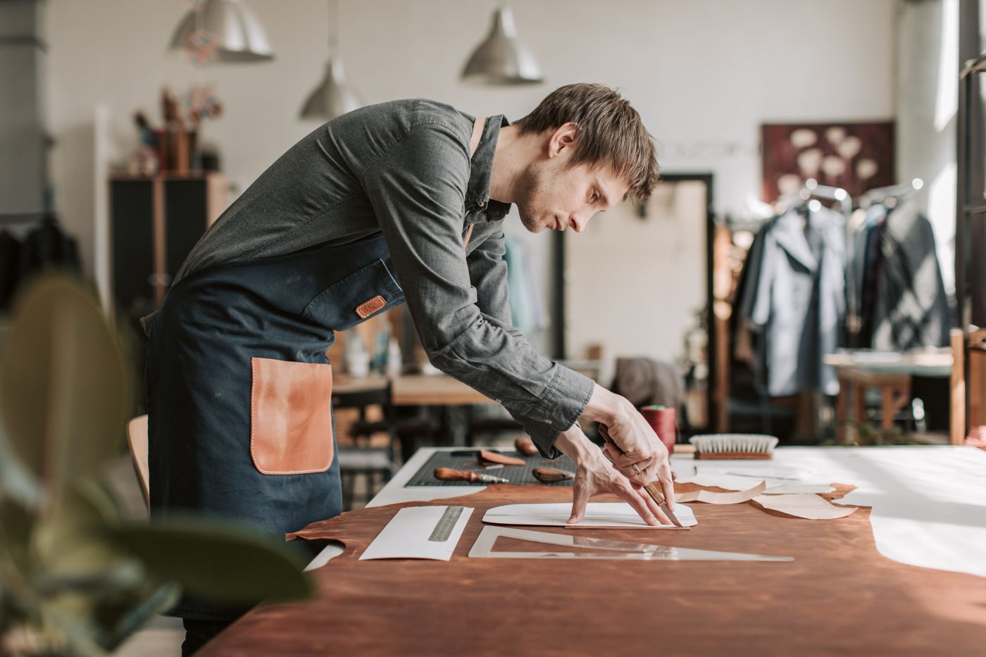 3d print for keychain — A skilled craftsman meticulously works on leather, showcasing traditional craftsmanship in a well-lit workshop