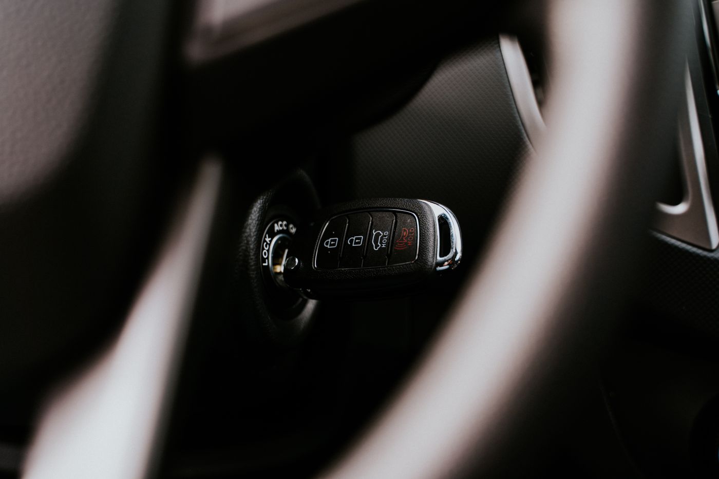 personalised keychain for car — A close-up view of a car key placed in the ignition inside a vehicle, highlighting automotive detail