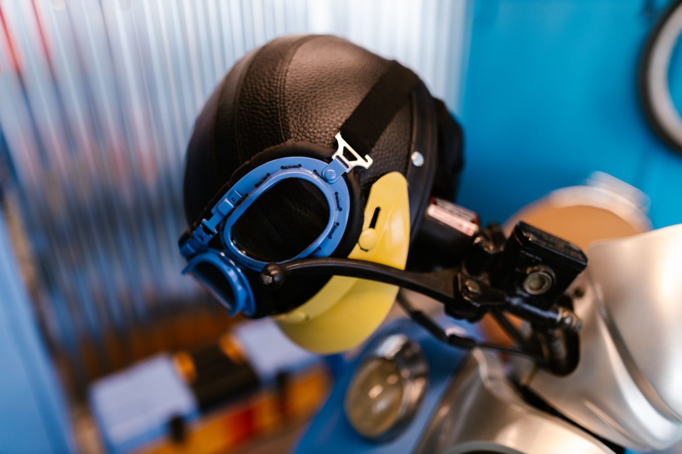 3d printed accessories for motorcycle — Close-up of a vintage-style motorcycle helmet and goggles on display indoors