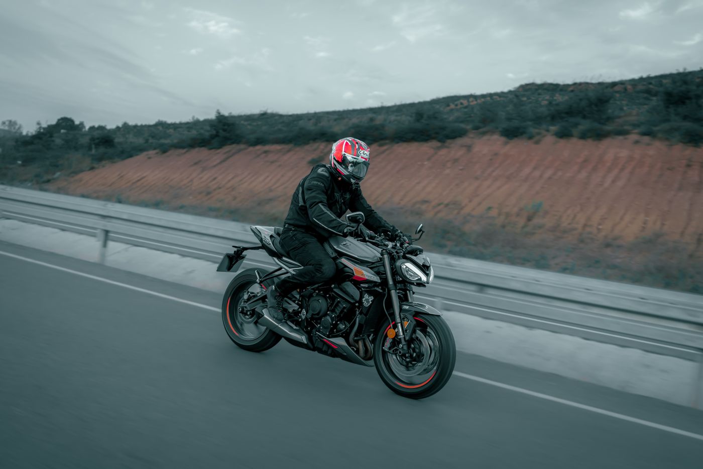 cartoon stickers for bike — A biker on a black motorcycle cruising along an open highway, showcasing speed and freedom