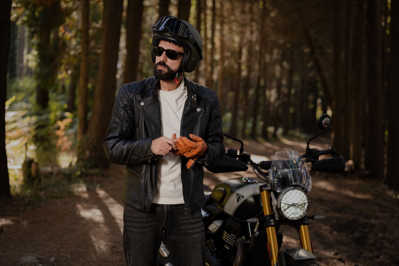 cartoon stickers for bike — Man in leather jacket preparing to ride motorcycle in peaceful forest
