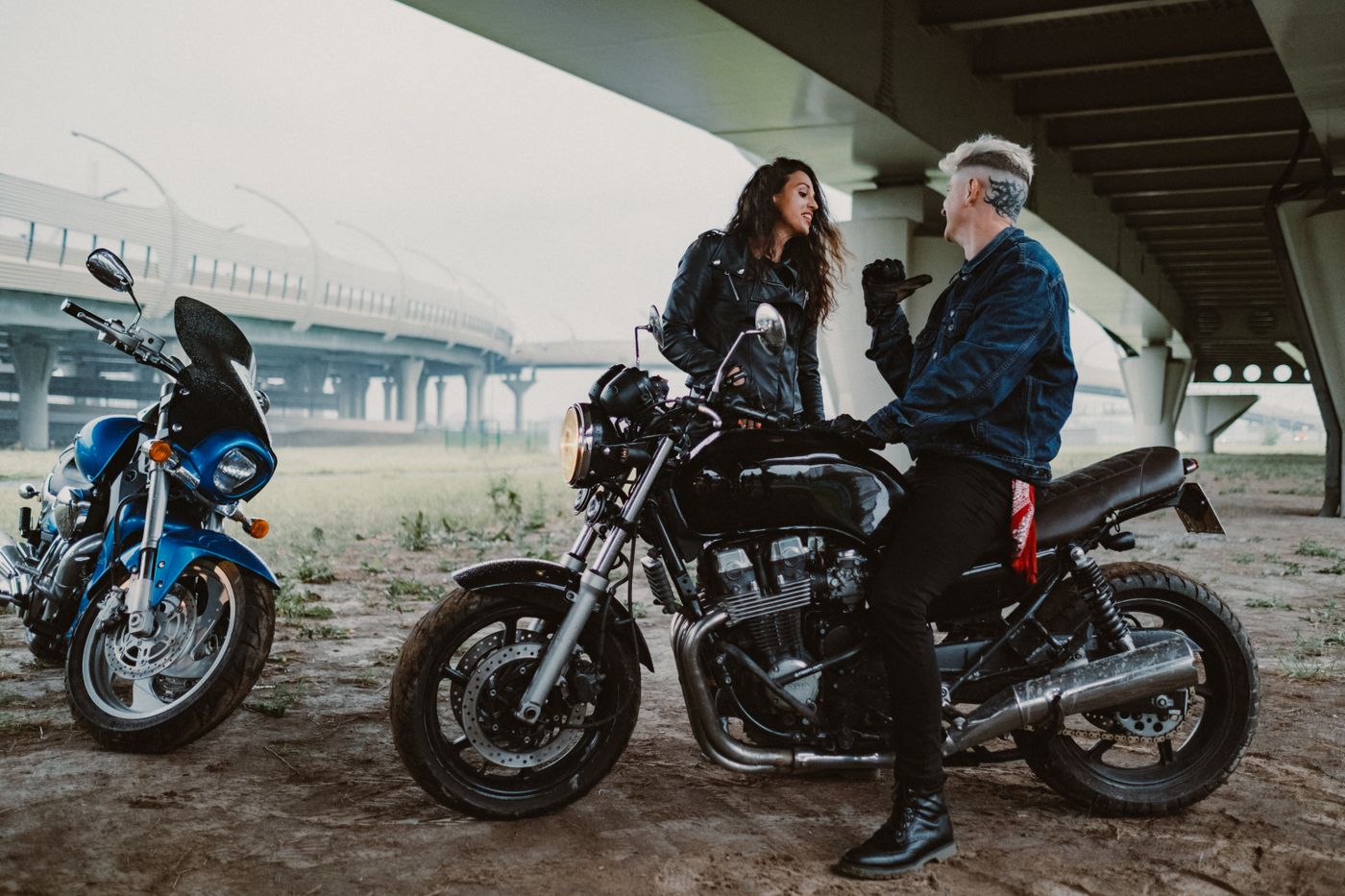 cartoon stickers for bike — A couple sharing a moment on motorcycles underneath a modern bridge