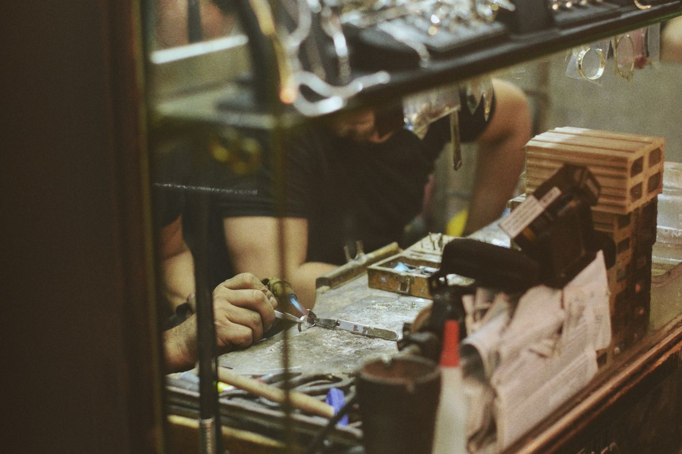 personalised keychains online india — Close-up of an artisan at work in a jewelry workshop, focusing on craftsmanship and tools