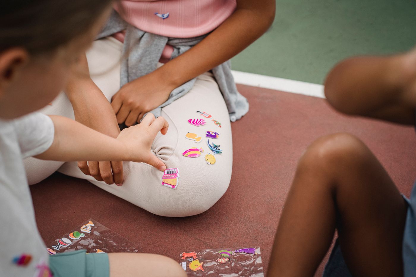 cartoon stickers for kids — Children having fun with colorful stickers on an outdoor court