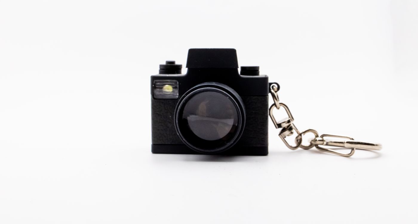 name keychain cricut — A miniature camera-shaped keychain against a simple white background, perfect for photography enthusiasts