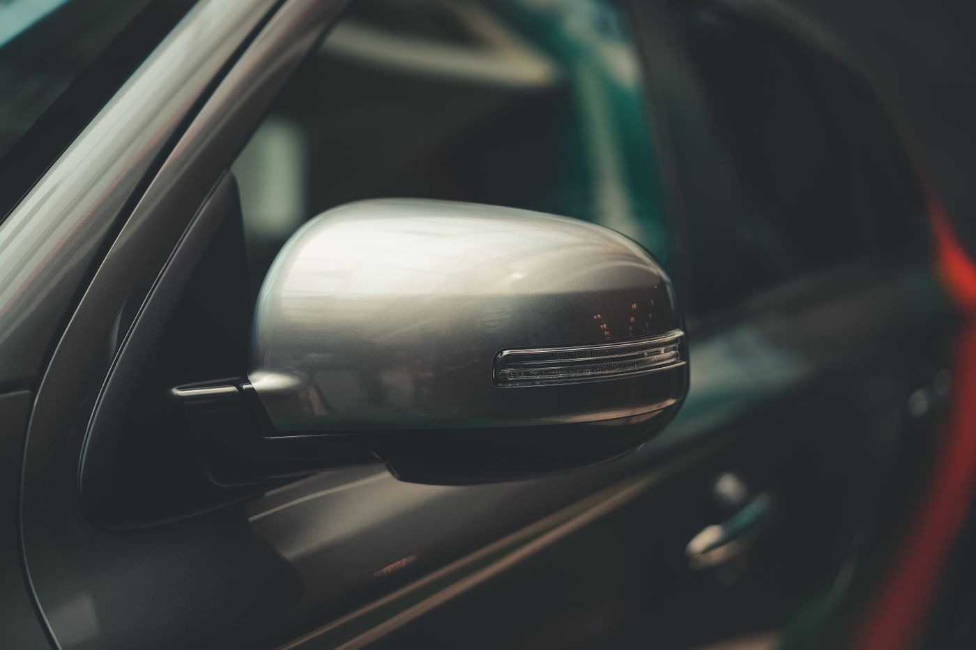 fortuner keychain — A detailed close-up of a car's chrome side mirror, showcasing modern design