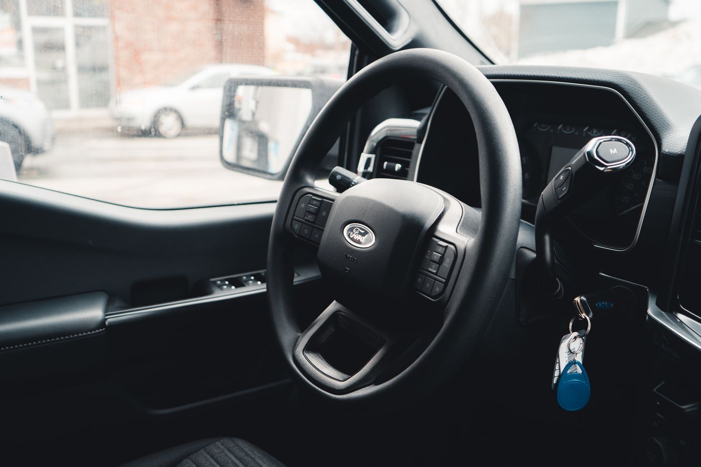 fortuner keychain — Interior view of a Ford vehicle showing steering wheel, dashboard, and car keys for modern automotive design