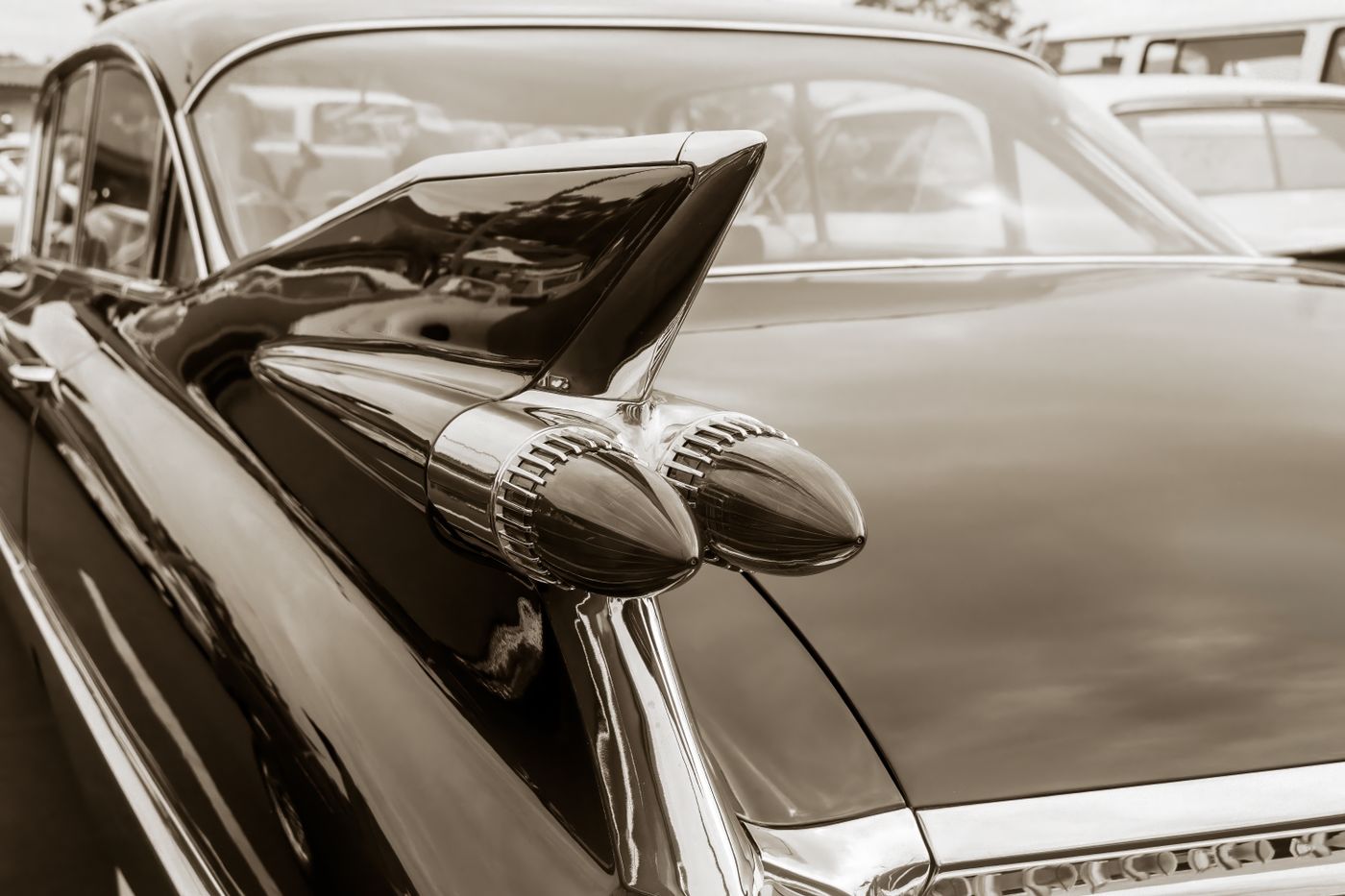 fortuner keychain — Elegant sepia close-up of a vintage car's iconic rear fin design