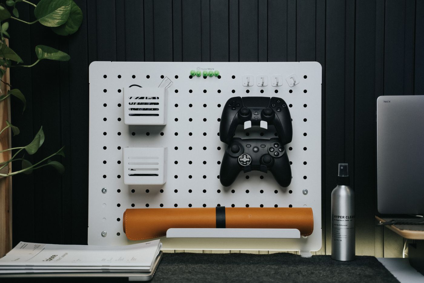 3d printed phone stand — Minimalist workspace with a pegboard displaying game controllers and tech accessories
