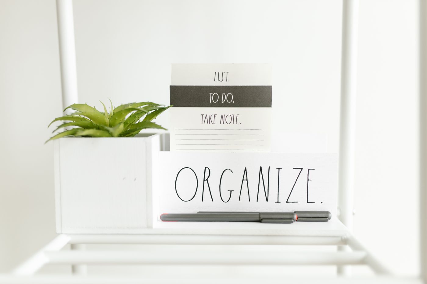 3d printed phone stand — A minimalist setup featuring a to-do list, plant, and pens for organized productivity