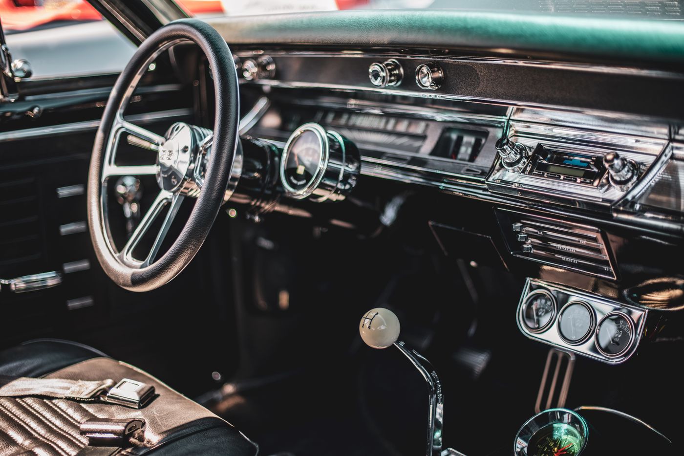 thar keychain — A detailed view of a classic car's interior featuring a vintage dashboard and steering wheel