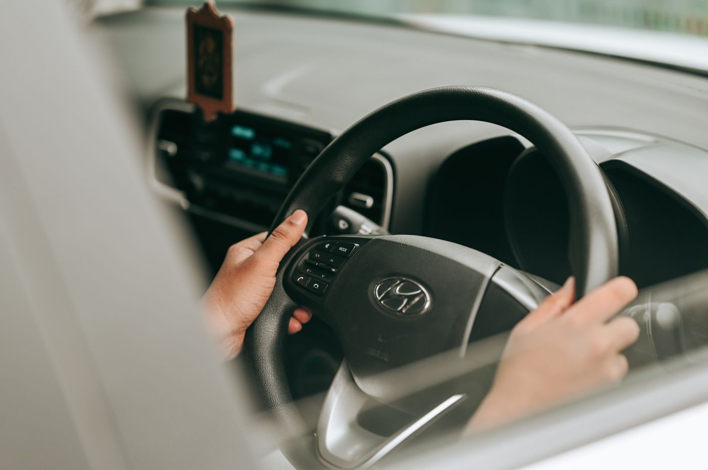 thar keychain — Close-up view of hands holding the steering wheel inside a car