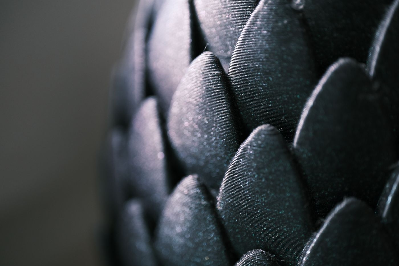 3d printed lamp — Intricate close-up of glossy black scale-like pattern with a captivating texture and shimmer