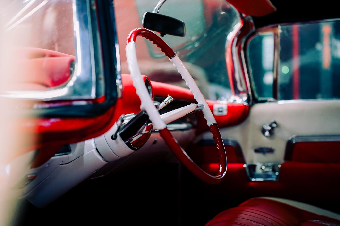 ev car keychain india — A detailed view of a classic car's interior with vibrant red and white accents