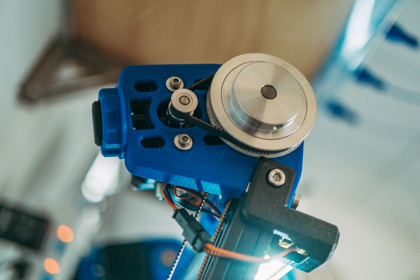 common 3d printing problems — Detailed view of a 3D printer's belt pulley mechanism in operation