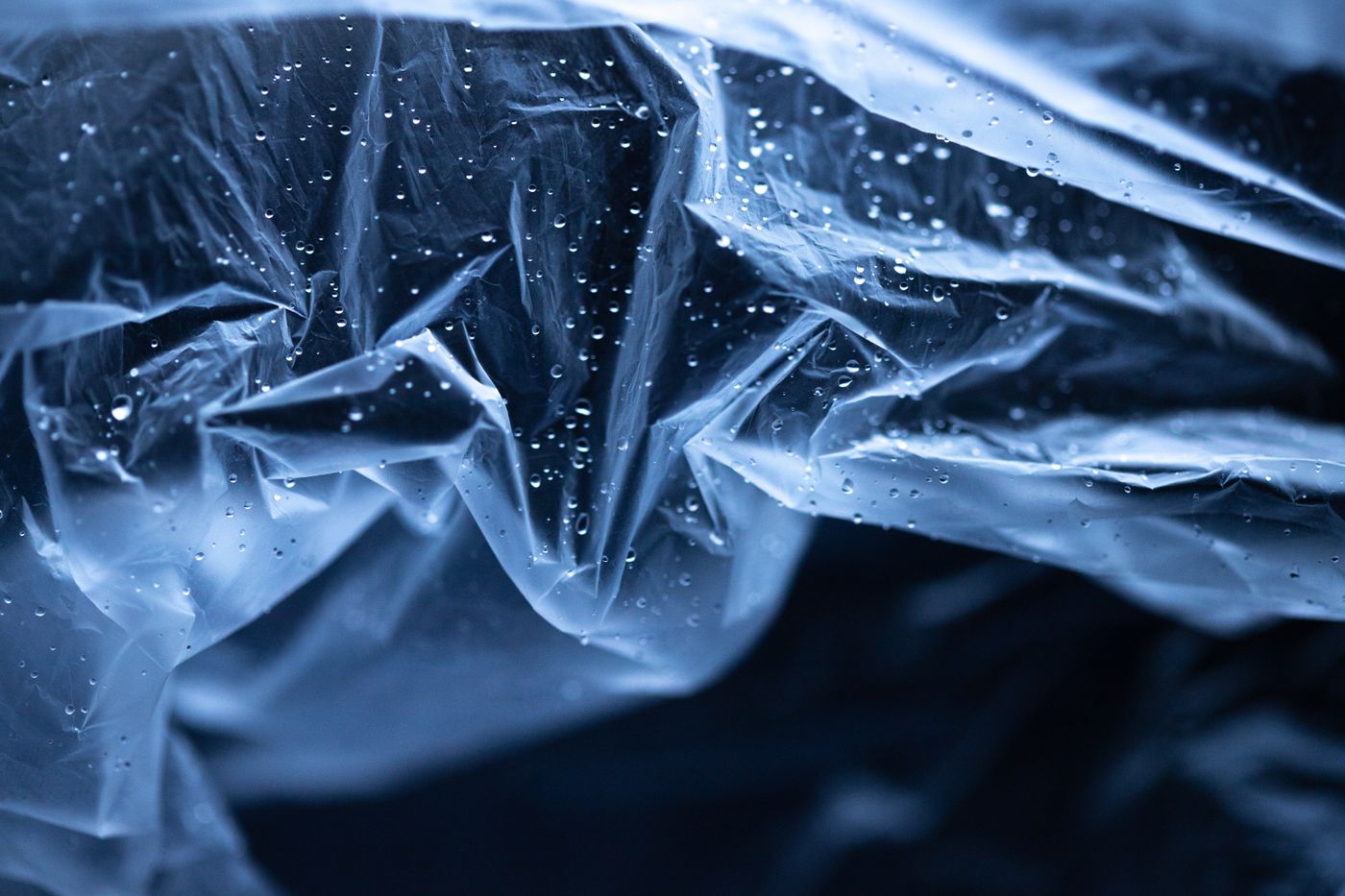 is pla waterproof — Abstract image of transparent plastic with water droplets. High contrast and cool tones enhance the texture