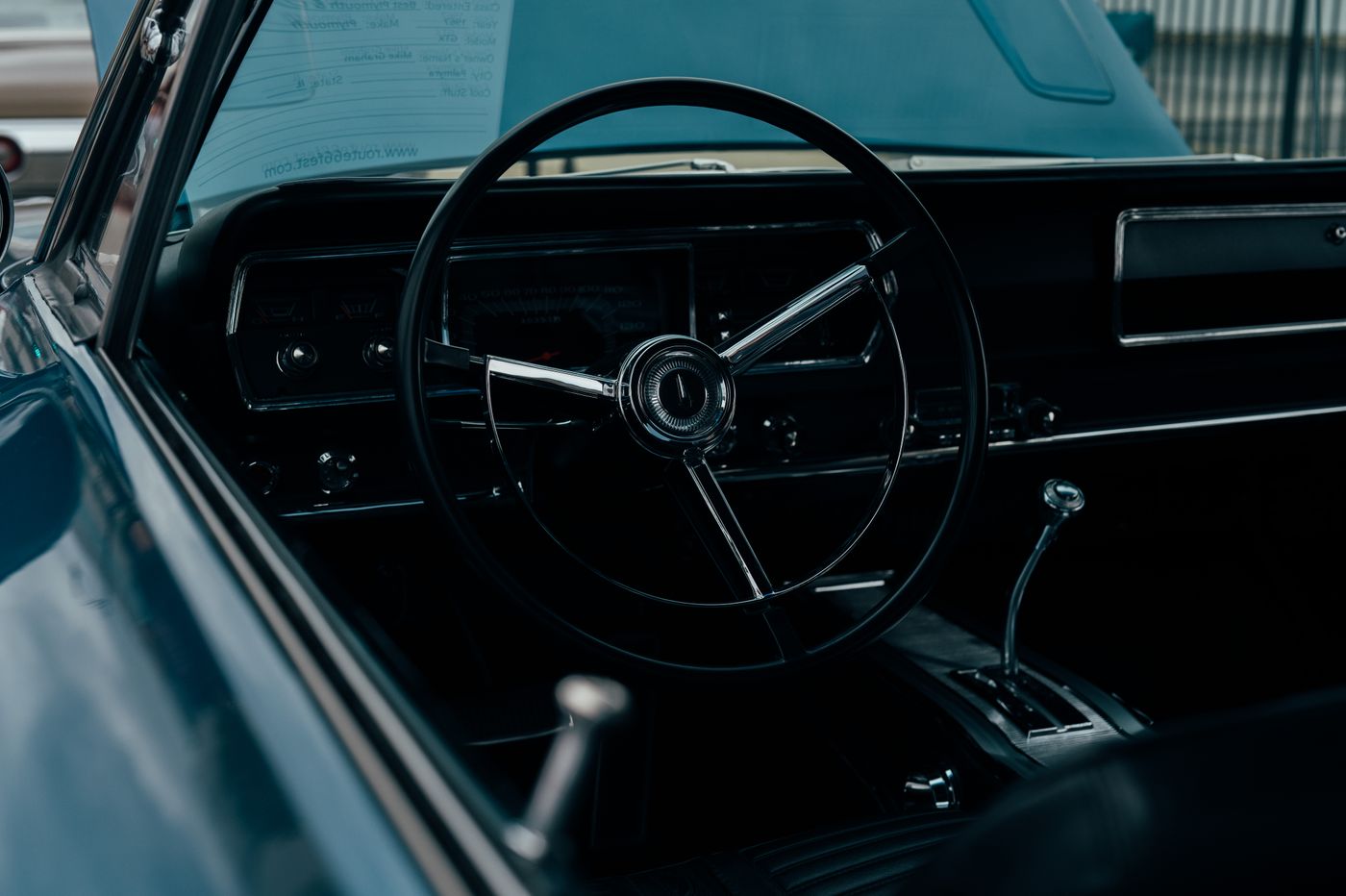 scooter keychain — Vintage car interior featuring a classic steering wheel and dashboard in moody lighting