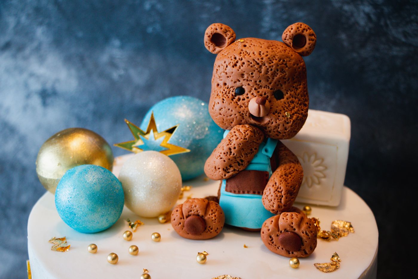 3d printed cake topper — Adorable teddy bear cake topper surrounded by glittery spheres and a festive design, perfect for celebrations