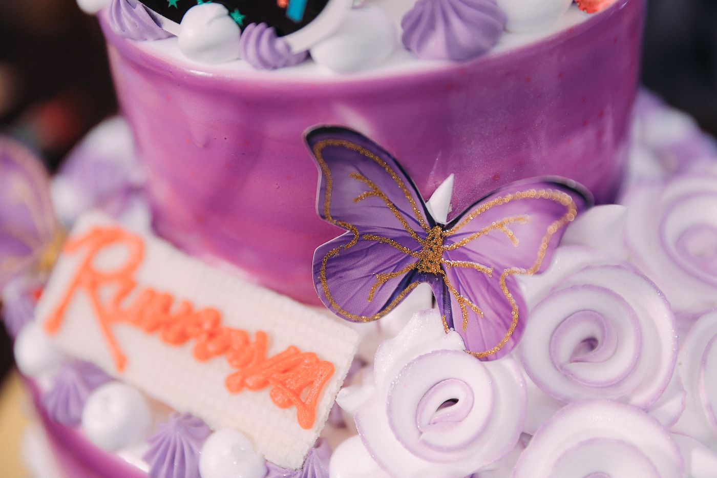 3d printed cake topper — Close-up of a purple birthday cake featuring a butterfly decoration and custom text topper