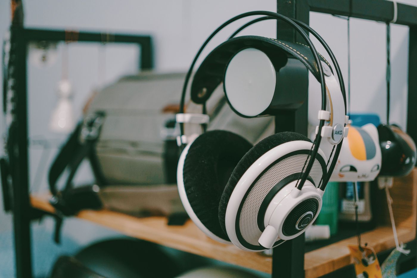 3d printed headphone stand — Close-up of AKG headphones hanging on a shelf in an indoor setting