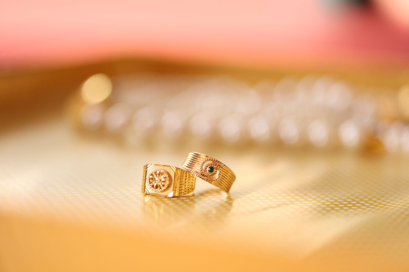 3d printed jewellery — Close-up of gold rings on a textured surface, capturing elegance and sophistication