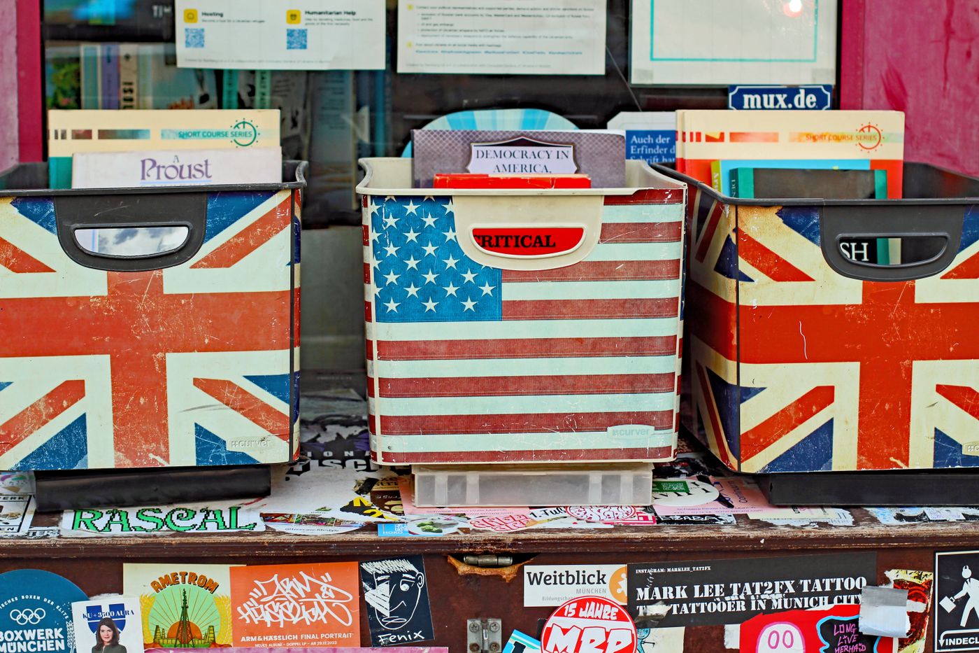 vinyl sticker printing — Colorful book boxes with flags of UK and USA at a bookstore in München