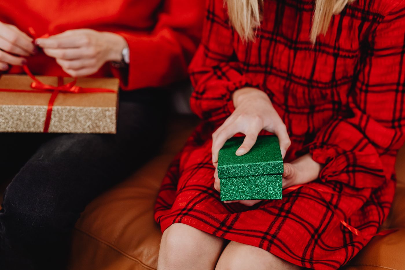 alphabet keychain — Two people exchanging gifts, highlighting the festive spirit with colorful presents