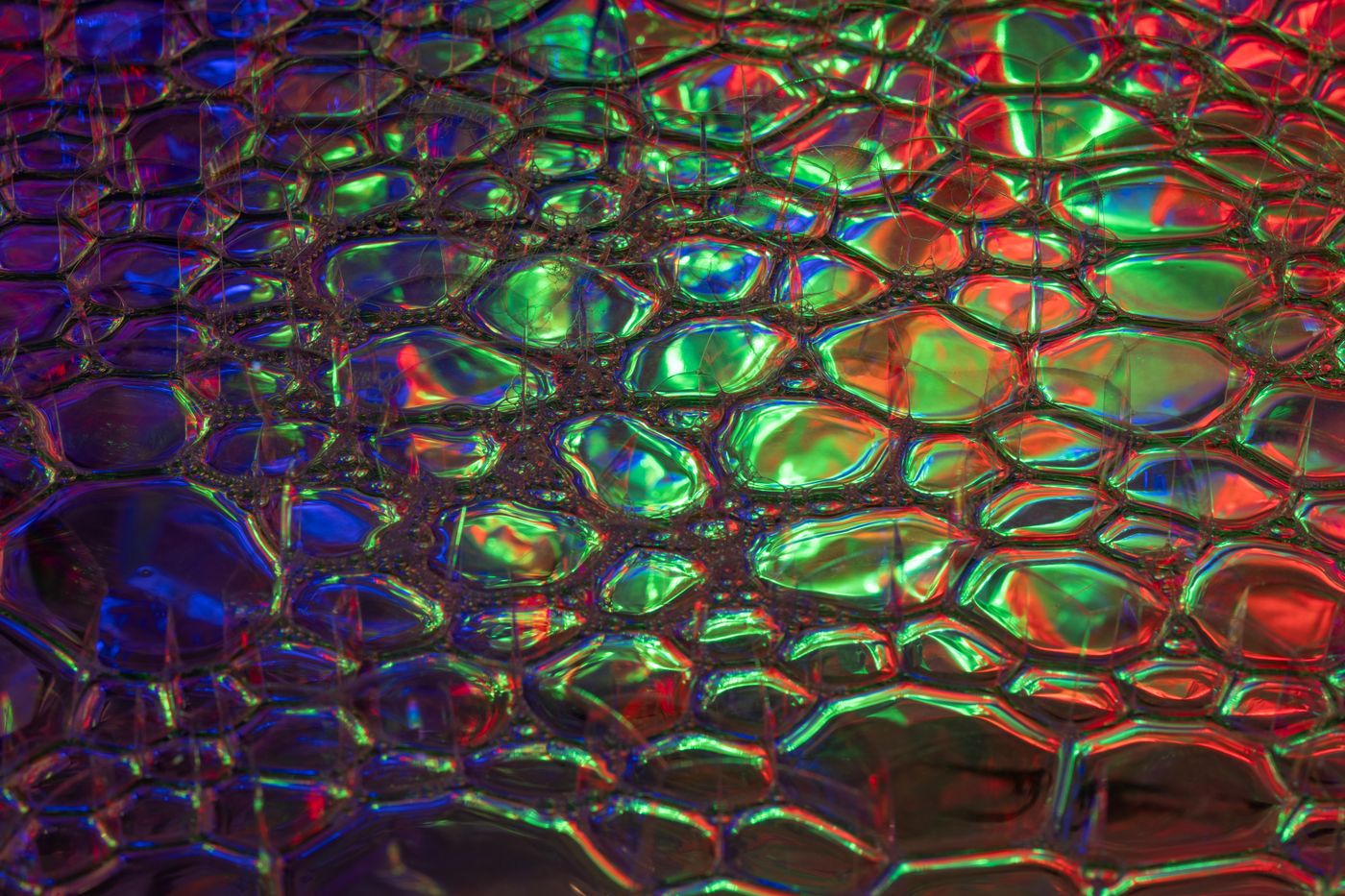 holographic stickers — A colorful, abstract texture featuring vibrant reflections and holographic patterns. Ideal for creative backgrounds