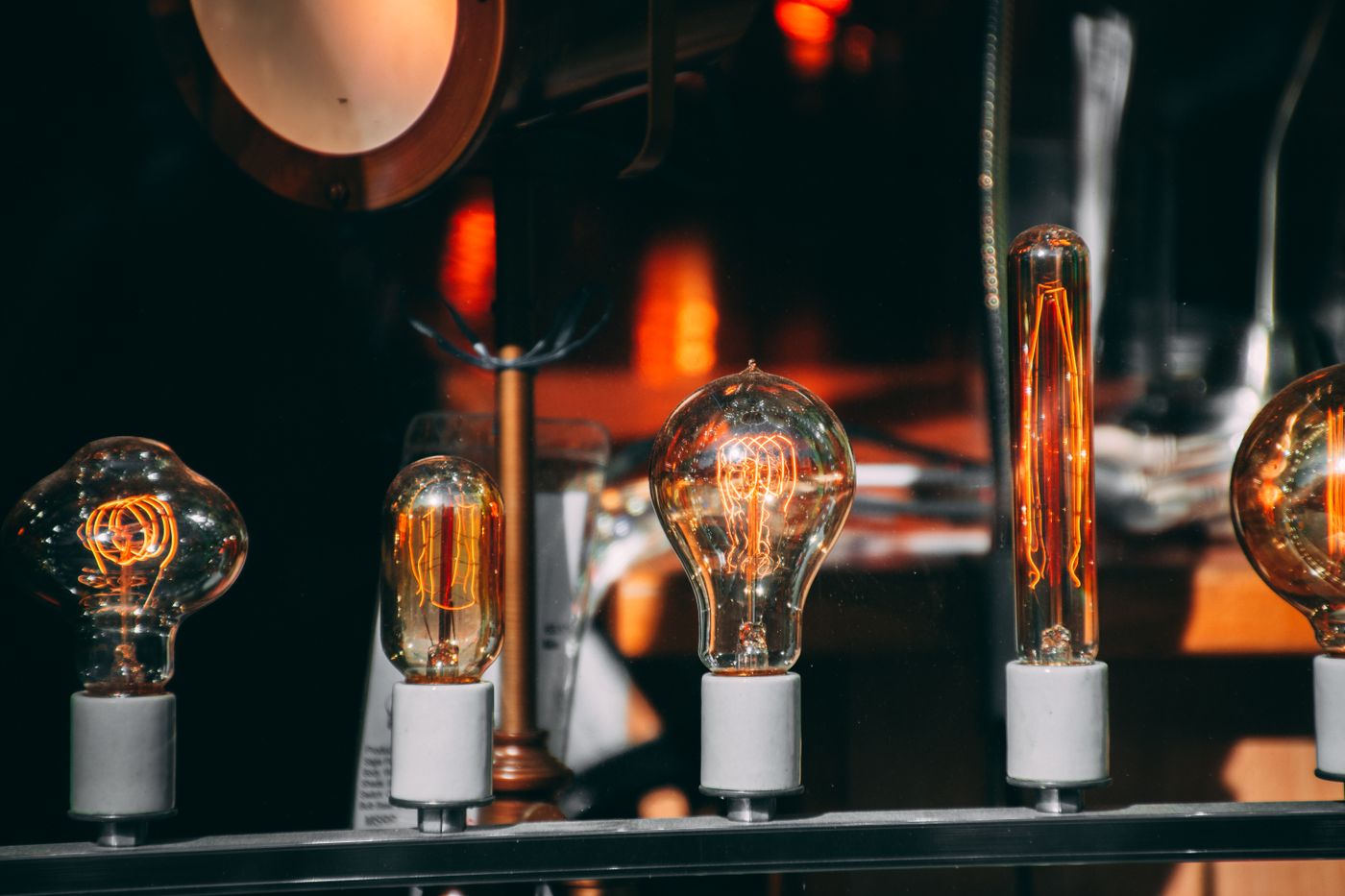 filament drying — A collection of vintage Edison light bulbs glowing warmly, showcasing intricate filaments